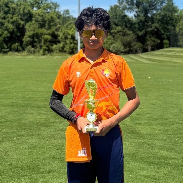 Preet Patel holding a trophy